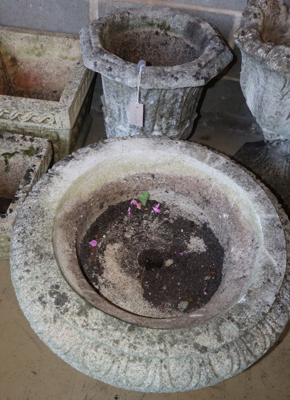 Two reconstituted stone campana garden urns, larger 58cm diameter, H.36cm